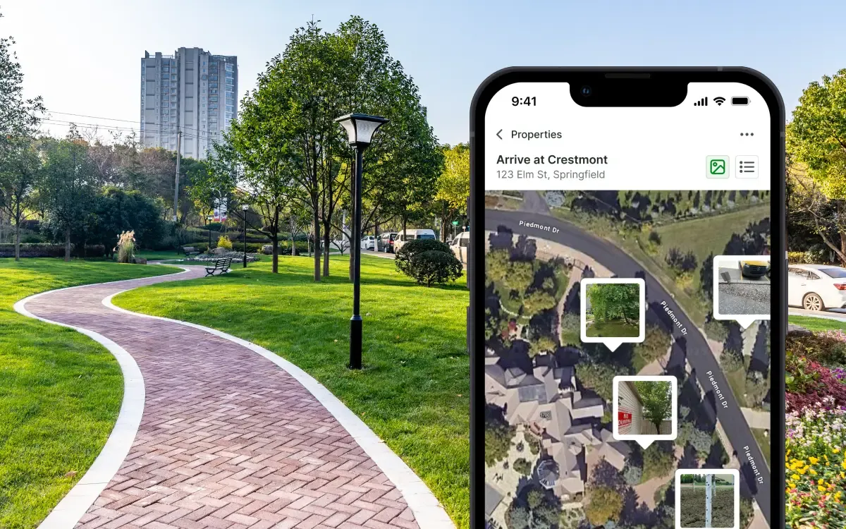 SiteDNA on iPhone displaying a property file with a satellite map view and on-site photo thumbnails, overlaid on a real commercial maintenance property with a curving brick walkway, mature shade trees, and manicured lawns at a residential community.